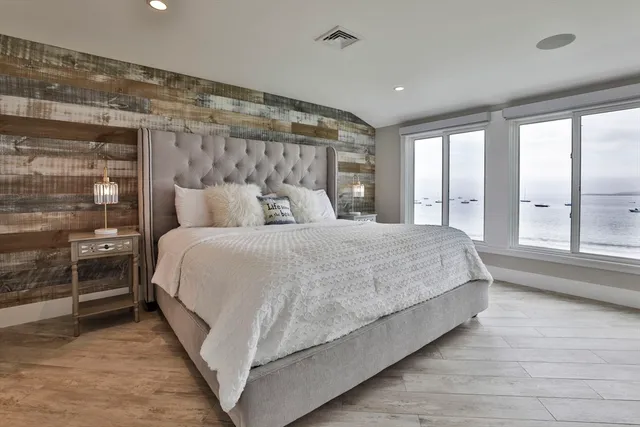 a bedroom with a large bed and a large window