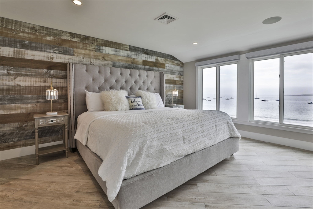 45 Raymond Street, Unit 7 Manchester, MA 01944 - Photo 19 of 40 a bedroom with a large bed and a large window