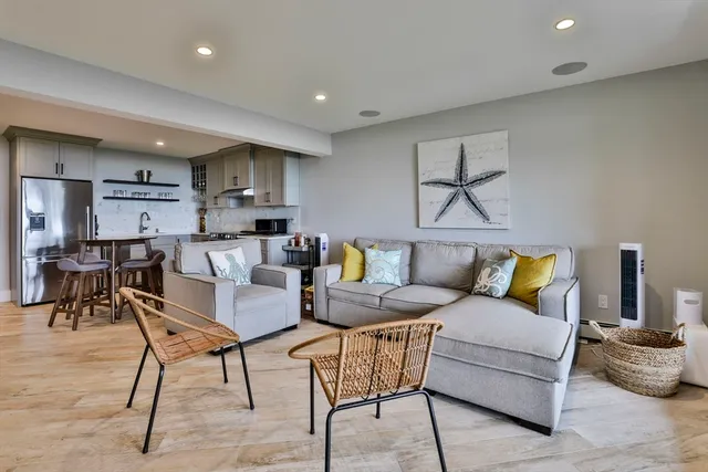 a living room with furniture and kitchen view