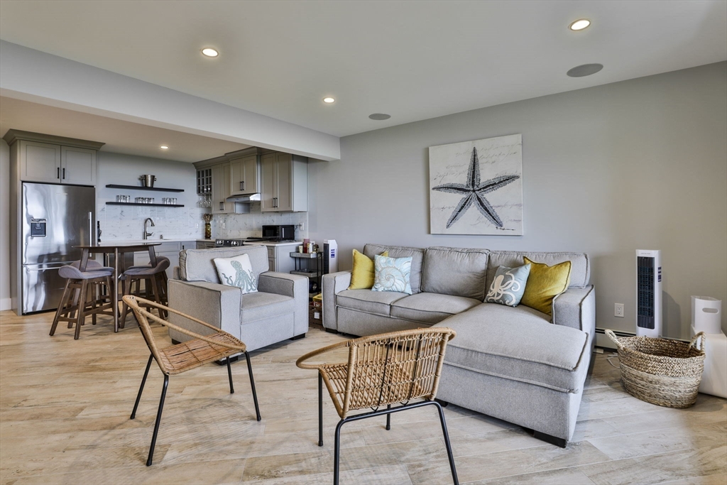45 Raymond Street, Unit 7 Manchester, MA 01944 - Photo 23 of 40 a living room with furniture and kitchen view