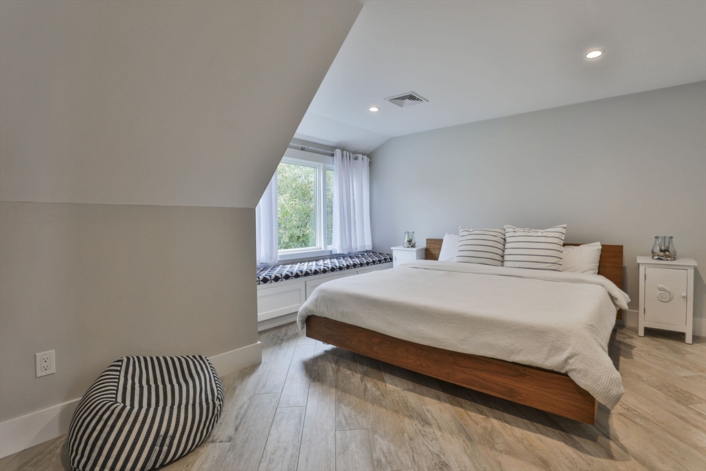 45 Raymond Street, Unit 7 Manchester, MA 01944 - Photo 30 of 40 a bedroom with a bed and a large window