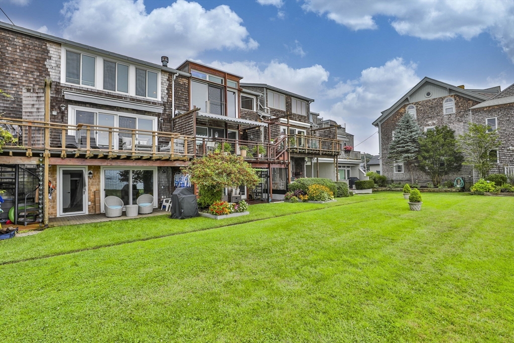 45 Raymond Street, Unit 7 Manchester, MA 01944 - Photo 36 of 40 a view of a building with a yard