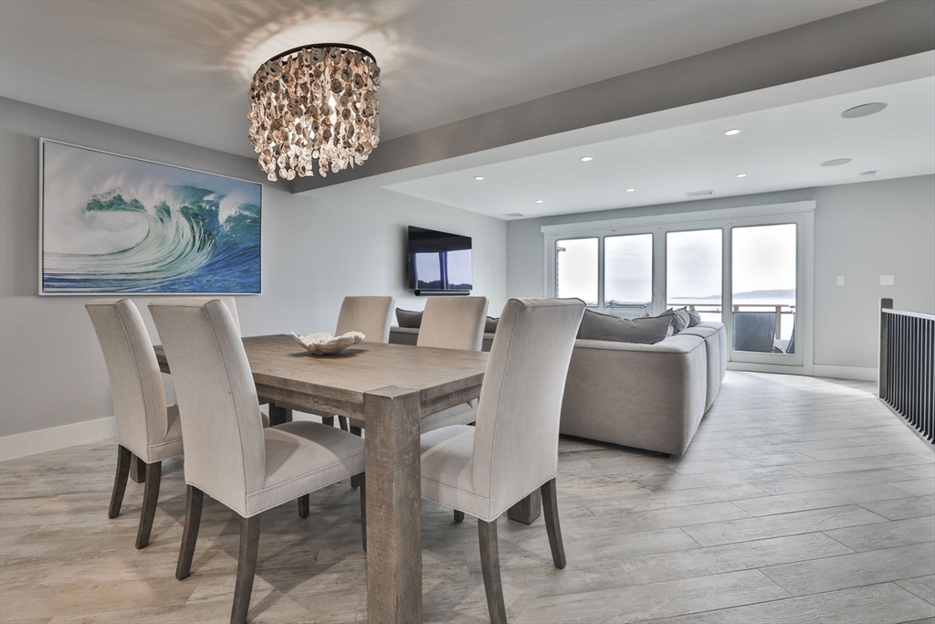 45 Raymond Street, Unit 7 Manchester, MA 01944 - Photo 8 of 40 a view of a dining room with furniture a chandelier and wooden floor