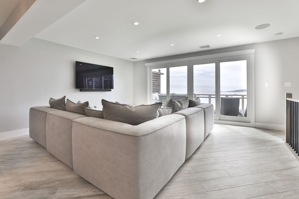 45 Raymond Street, Unit 7 Manchester, MA 01944 - Photo 9 of 40 a living room with furniture and a flat screen tv