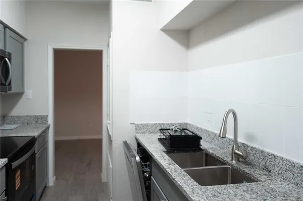 a kitchen with a sink and a stove