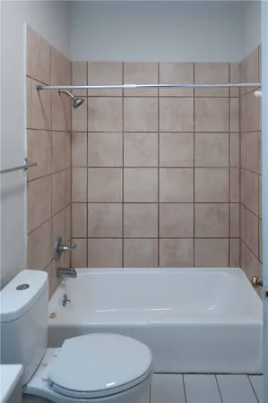 a bathroom with a toilet and bathtub