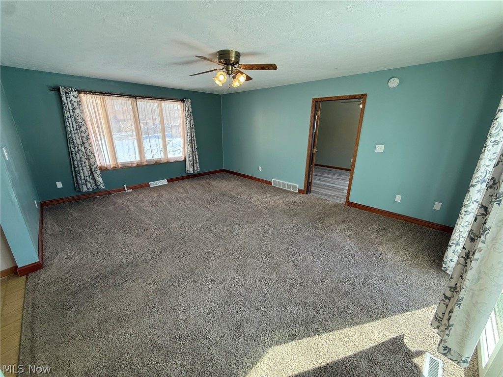 6784 Old Zoarville Road Northeast Dover, OH 44622 - Photo 16 of 50 Carpeted empty room featuring baseboards and a ceiling fan