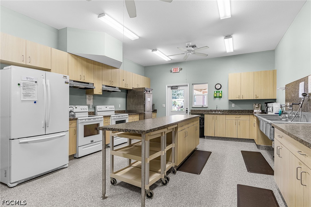 5 Erica Street Alva, FL 33920 - Photo 36 of 37 a kitchen with white cabinets and white appliances