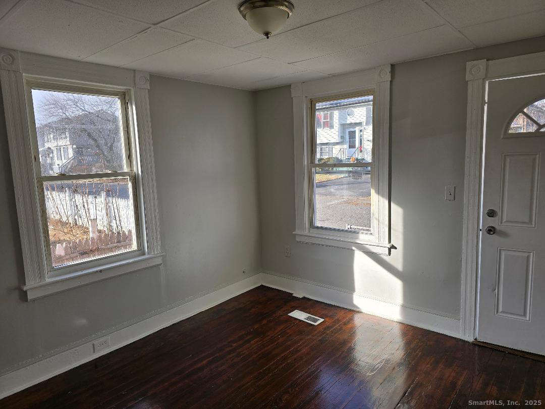 24 Cassidy Avenue Waterbury, CT 06704 - Photo 2 of 4 a view of an empty room with wooden floor and a window