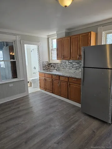 a kitchen with granite countertop a refrigerator and a stove