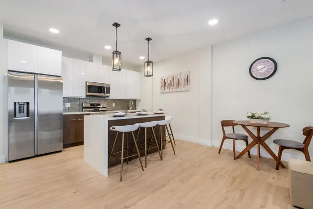 a kitchen that has a table and chairs in it
