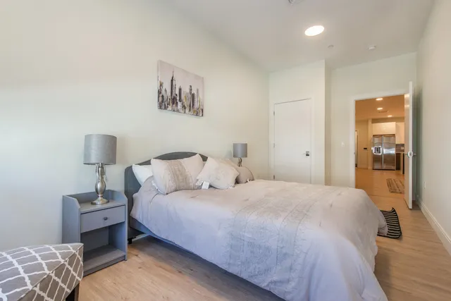 a bedroom with a bed and lamp