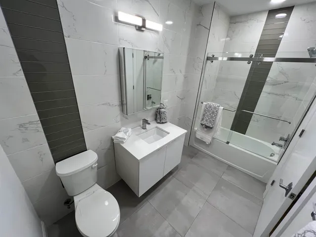 a white toilet sitting next to a bathroom sink