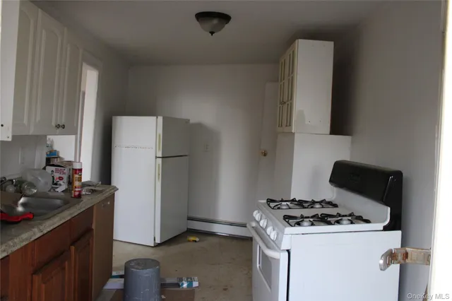 a kitchen with a stove and a refrigerator
