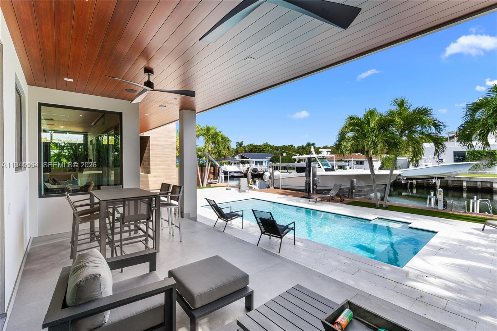12911 Oleander Road North Miami, FL 33181 - Photo 15 of 67 a view of a swimming pool with outdoor seating