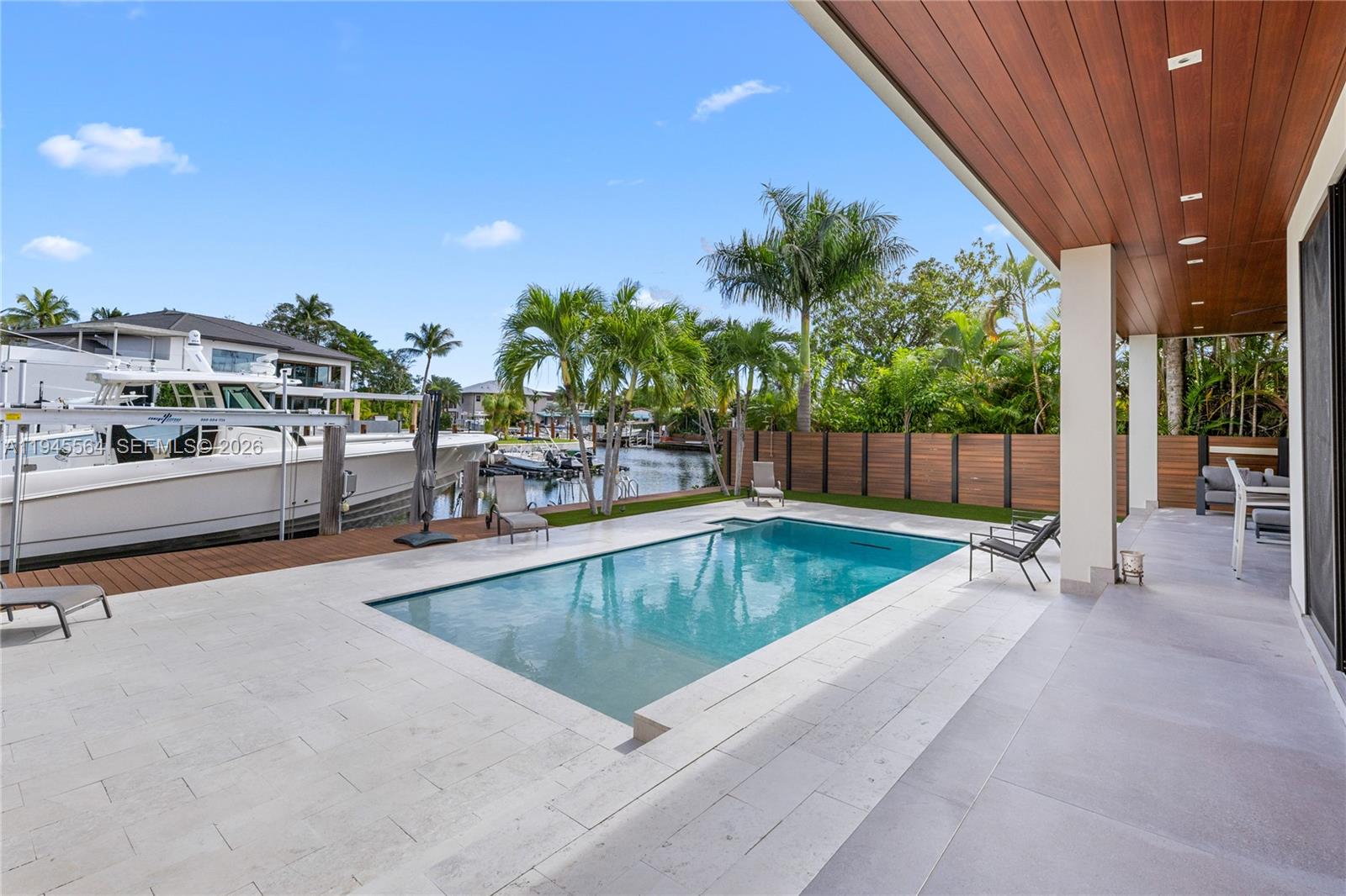 12911 Oleander Road North Miami, FL 33181 - Photo 16 of 67 a view of a swimming pool with a patio and garden