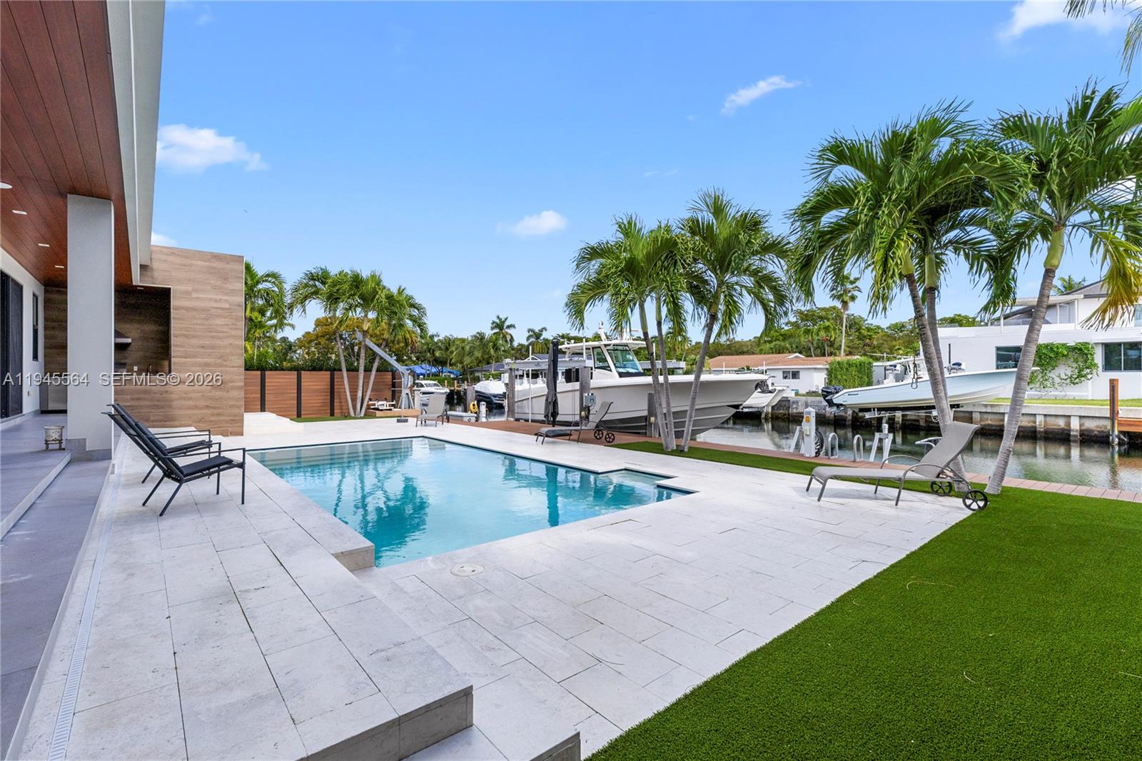 12911 Oleander Road North Miami, FL 33181 - Photo 19 of 67 a view of a swimming pool with chairs