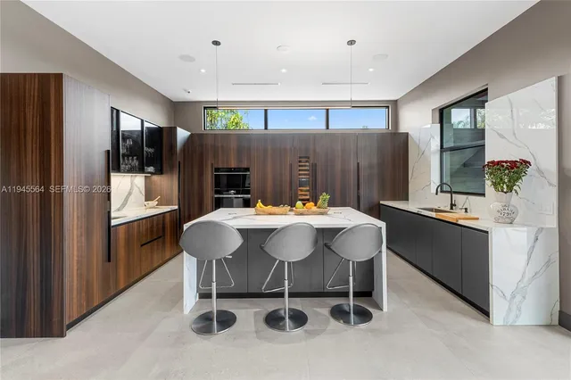 a living room with furniture kitchen view and a large window