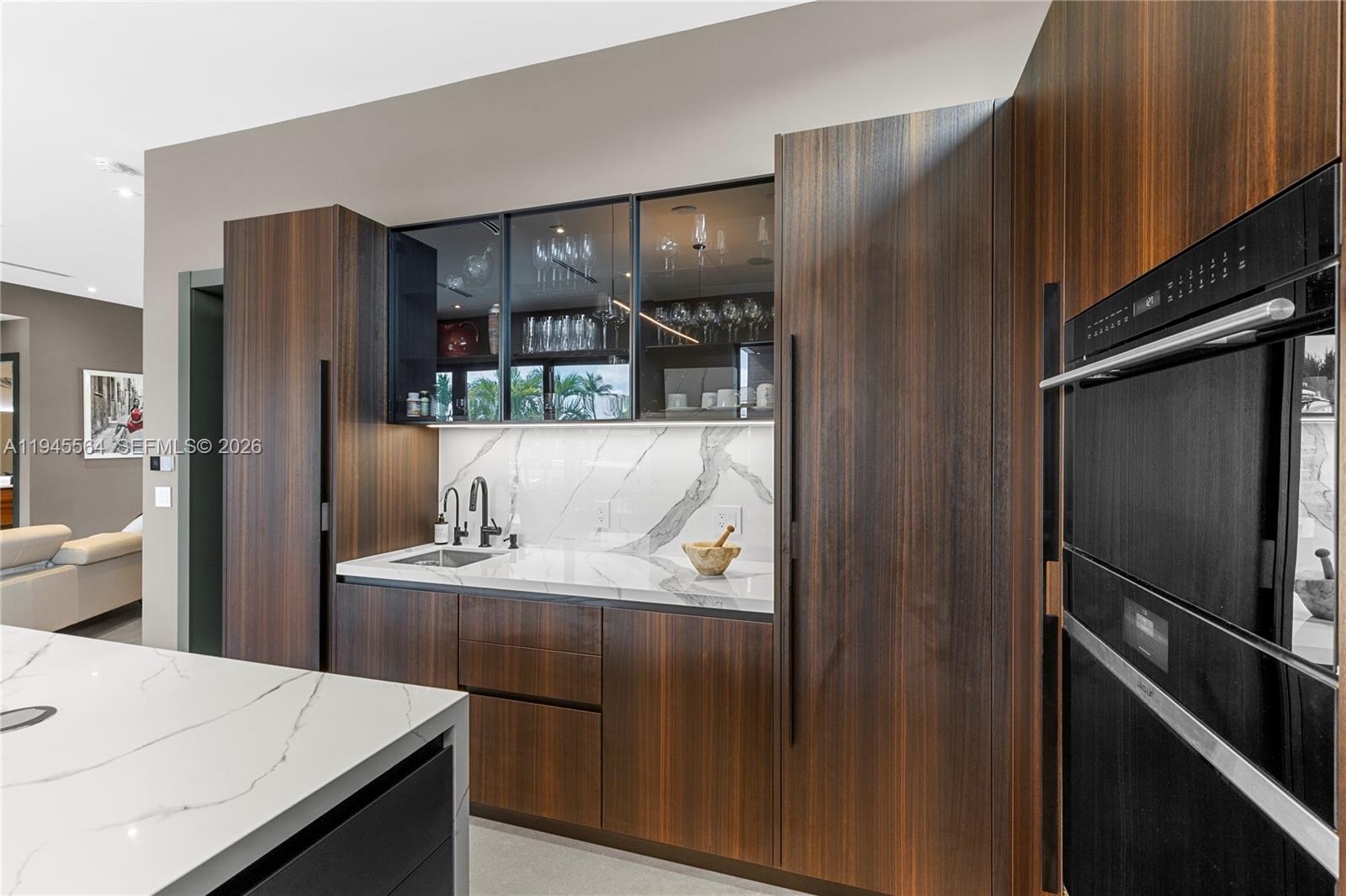 12911 Oleander Road North Miami, FL 33181 - Photo 22 of 67 a kitchen with kitchen island a counter top space cabinets and a refrigerator
