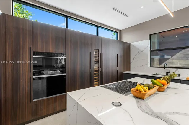 a living room with furniture and large windows