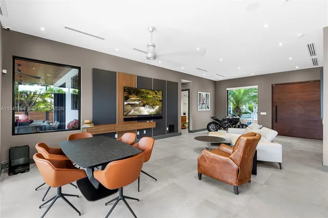 a view of a livingroom with furniture and floor to ceiling window