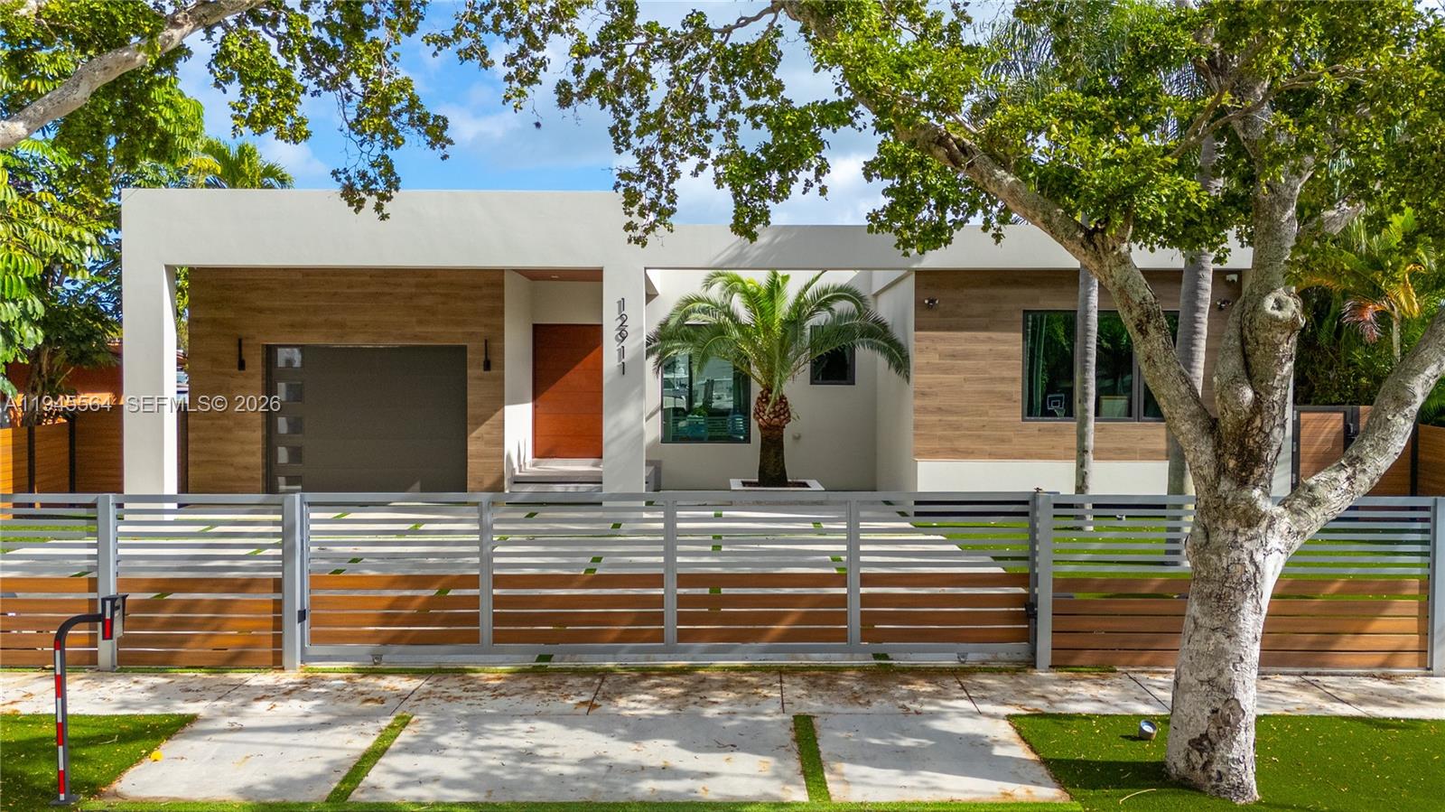 12911 Oleander Road North Miami, FL 33181 - Photo 3 of 67 a front view of a house with garden