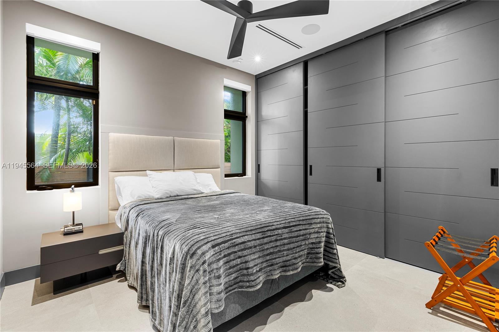 12911 Oleander Road North Miami, FL 33181 - Photo 44 of 67 a bedroom with a bed and a lamp on the dresser