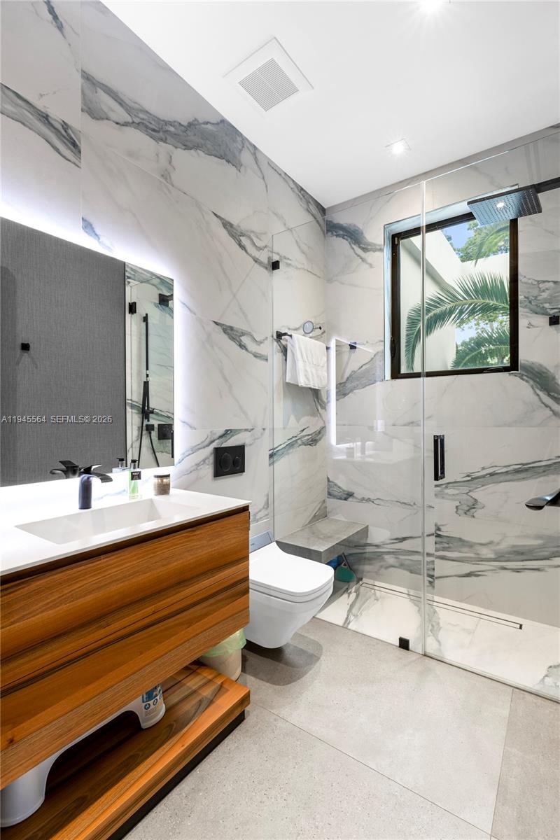 12911 Oleander Road North Miami, FL 33181 - Photo 47 of 67 a bathroom with a double vanity sink mirror and toilet