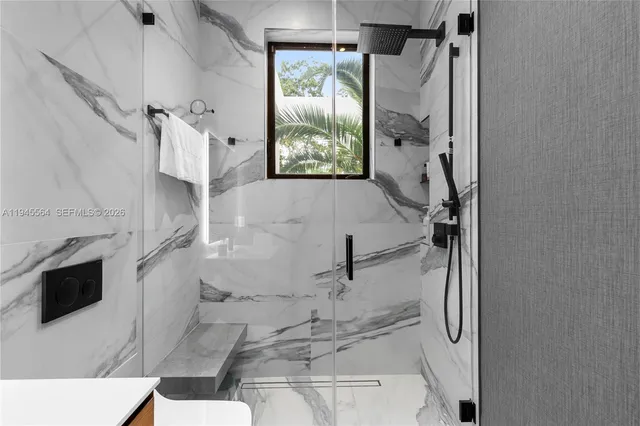 an aerial view of a city with lots of residential buildings ocean and mountain view in back