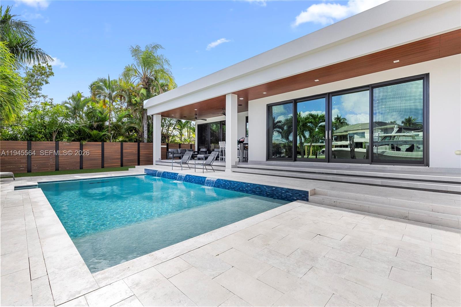 12911 Oleander Road North Miami, FL 33181 - Photo 49 of 67 a swimming pool with outdoor seating and yard