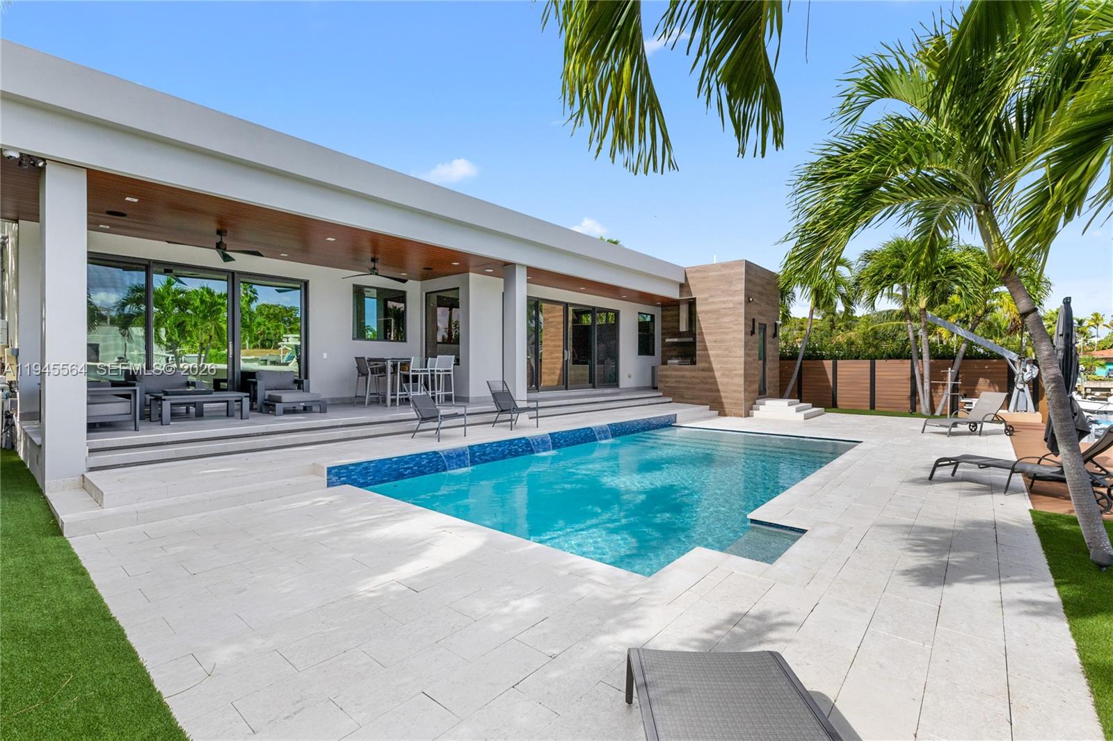 12911 Oleander Road North Miami, FL 33181 - Photo 50 of 67 a view of a house with swimming pool and a patio