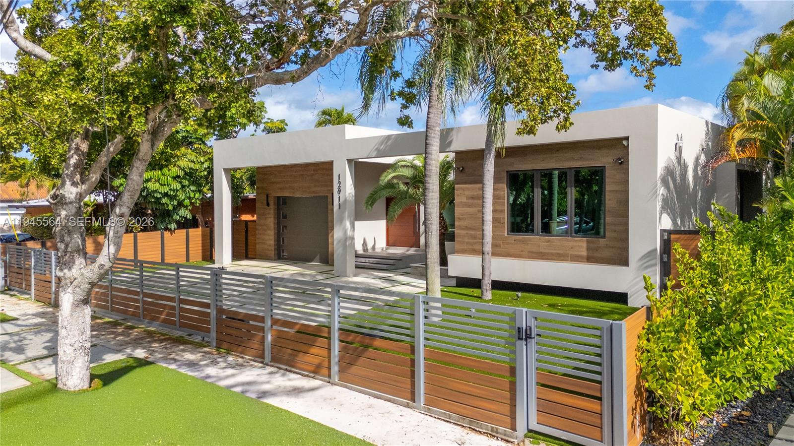 12911 Oleander Road North Miami, FL 33181 - Photo 5 of 67 front view of a house with a porch