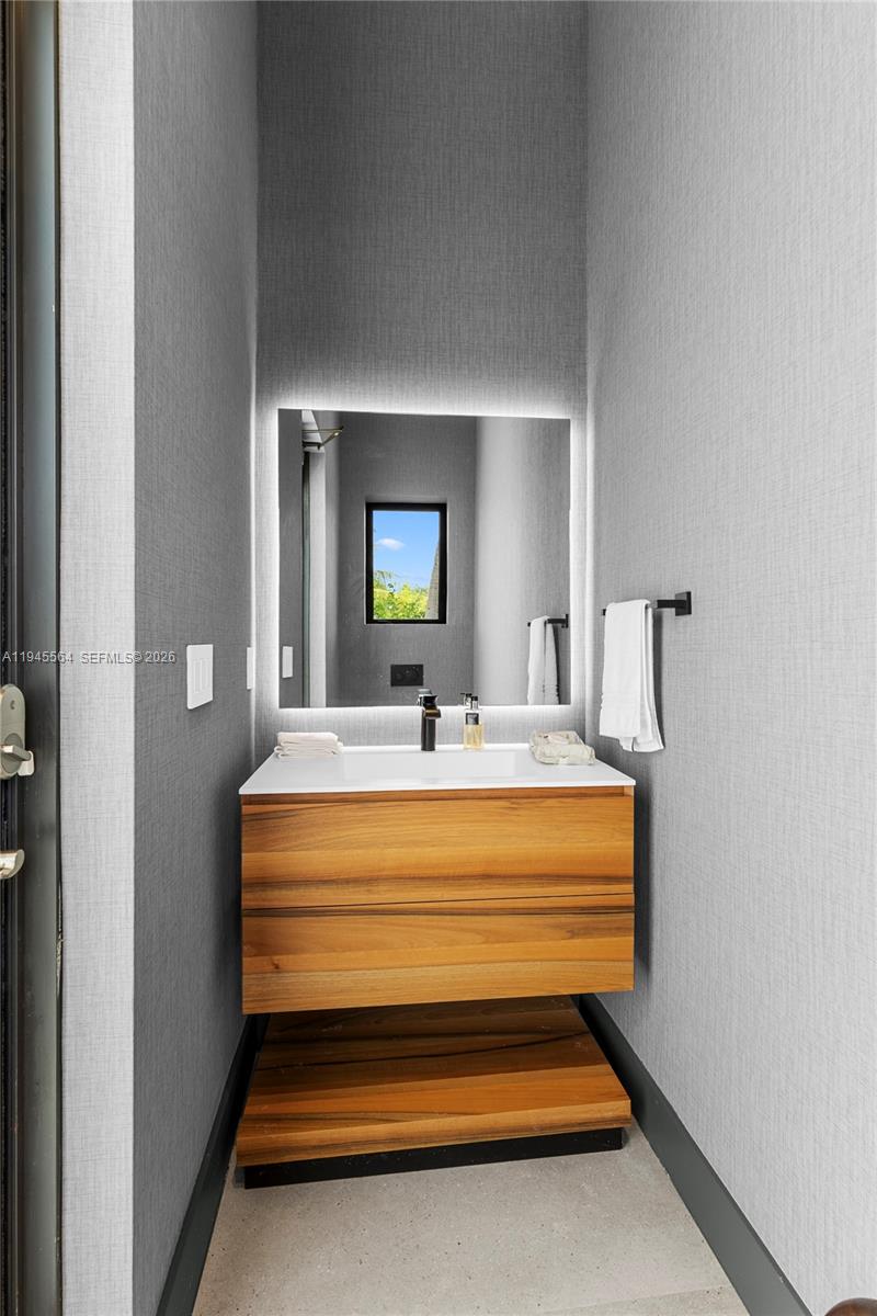 12911 Oleander Road North Miami, FL 33181 - Photo 52 of 67 a bathroom with a sink and a mirror