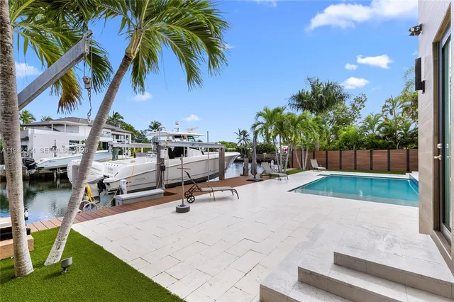 a view of a patio with swimming pool table and chairs