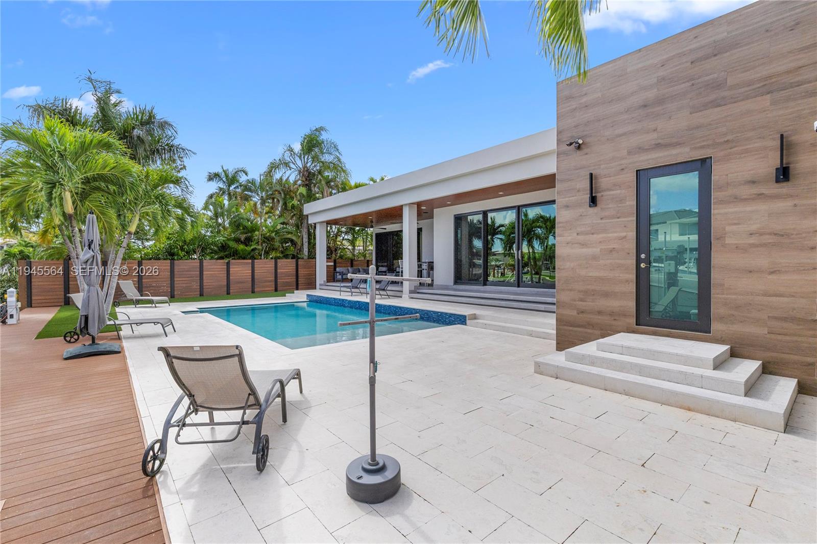 12911 Oleander Road North Miami, FL 33181 - Photo 10 of 67 a patio with a table and chairs and potted plants