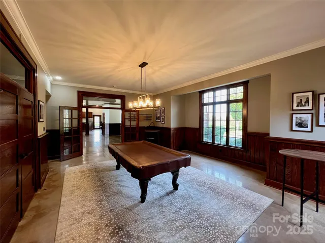 a room with lots of wooden furniture and glass windows
