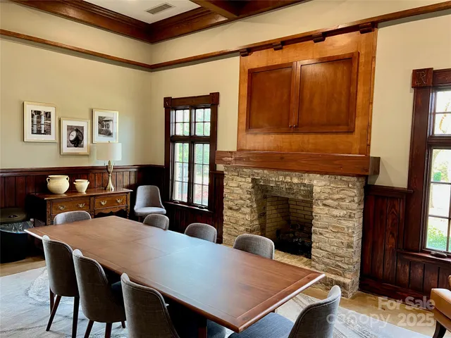 a living room with furniture a table and a fireplace