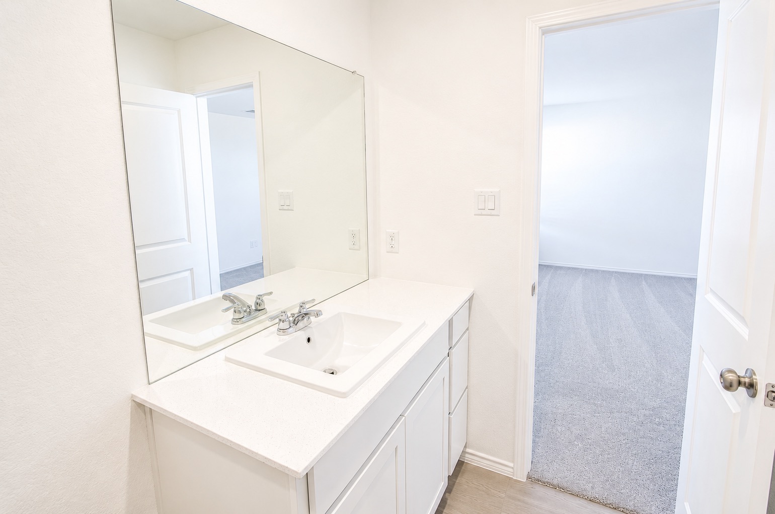 397 Keefer Kyle, TX 78640 - Photo 22 of 33 A well-appointed bathroom vanity with a spacious mirror and sleek, light-toned surfaces.