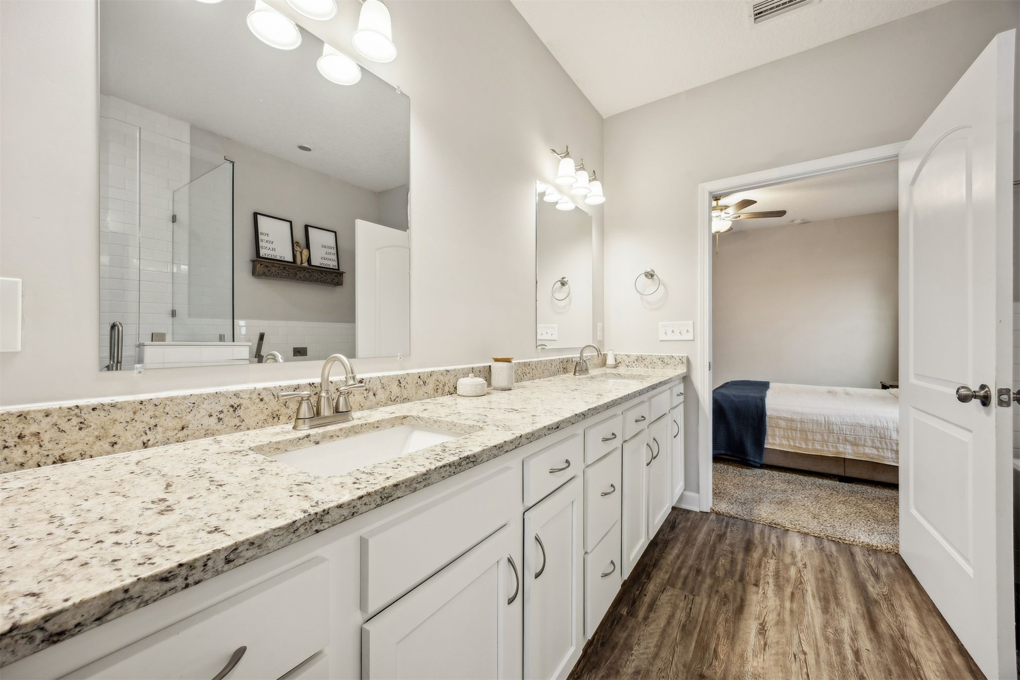 96718 Blackrock Road Yulee, FL 32097 - Photo 34 of 54 a bathroom with a granite countertop double vanity sink and mirror