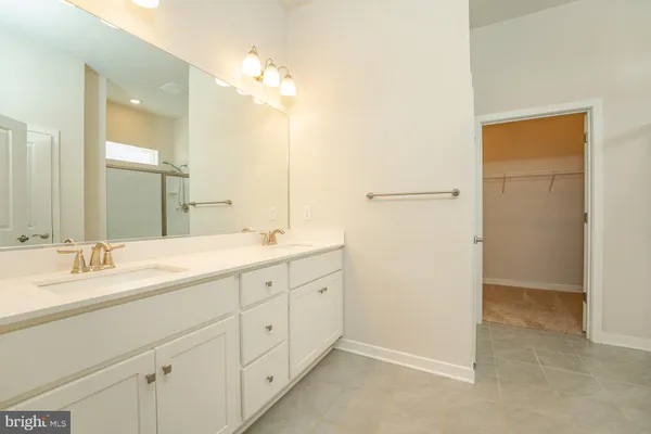 a bathroom with a double vanity sink and mirror