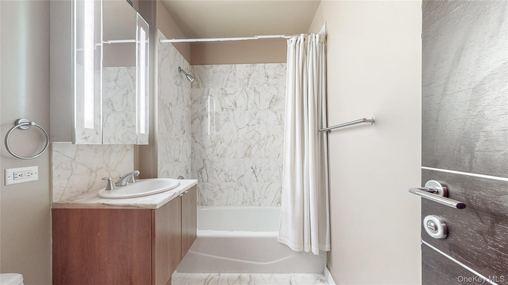 10724 71st Road, Unit 7E Queens, NY 11375 - Photo 11 of 21 Bathroom featuring shower / tub combo with curtain and vanity
