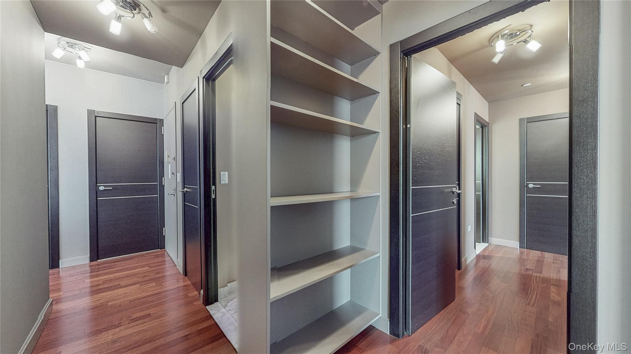 10724 71st Road, Unit 7E Queens, NY 11375 - Photo 13 of 21 Hallway with dark wood-style flooring and baseboards