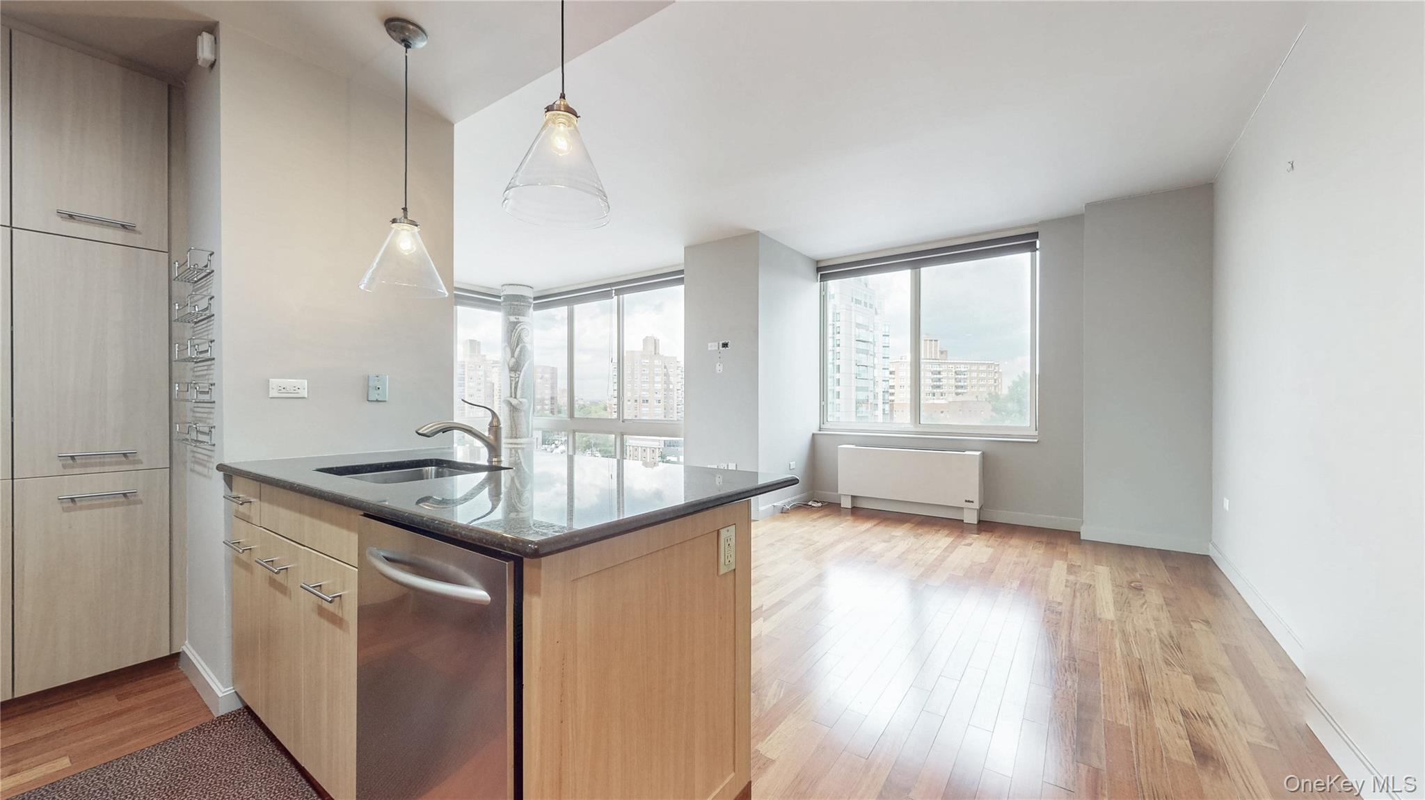 10724 71st Road, Unit 7E Queens, NY 11375 - Photo 3 of 21 Kitchen featuring dark stone counters, light brown cabinetry, dishwasher, pendant lighting, and light wood-style floors