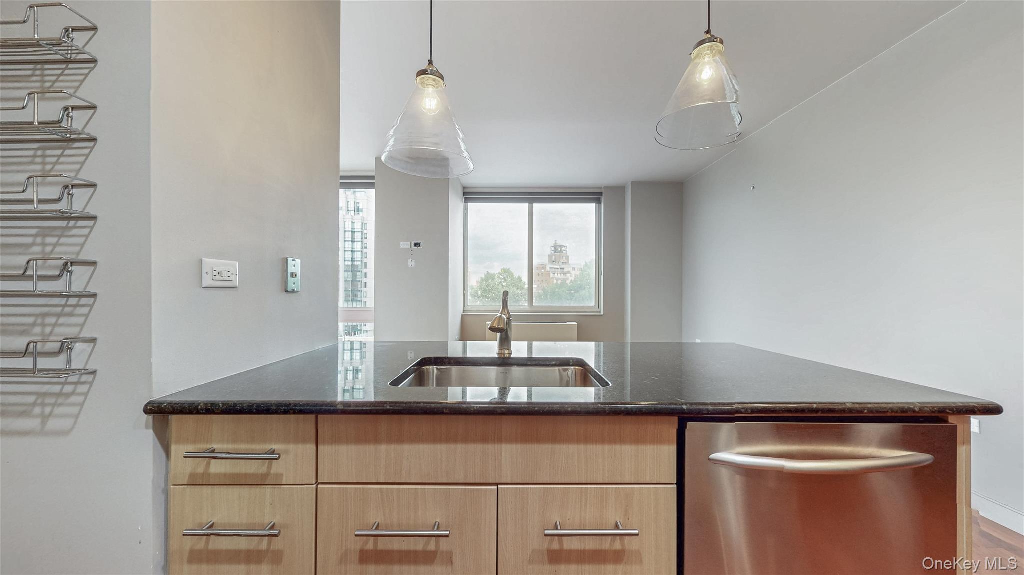 10724 71st Road, Unit 7E Queens, NY 11375 - Photo 6 of 21 Kitchen featuring dishwasher, dark stone countertops, decorative light fixtures, and light brown cabinets