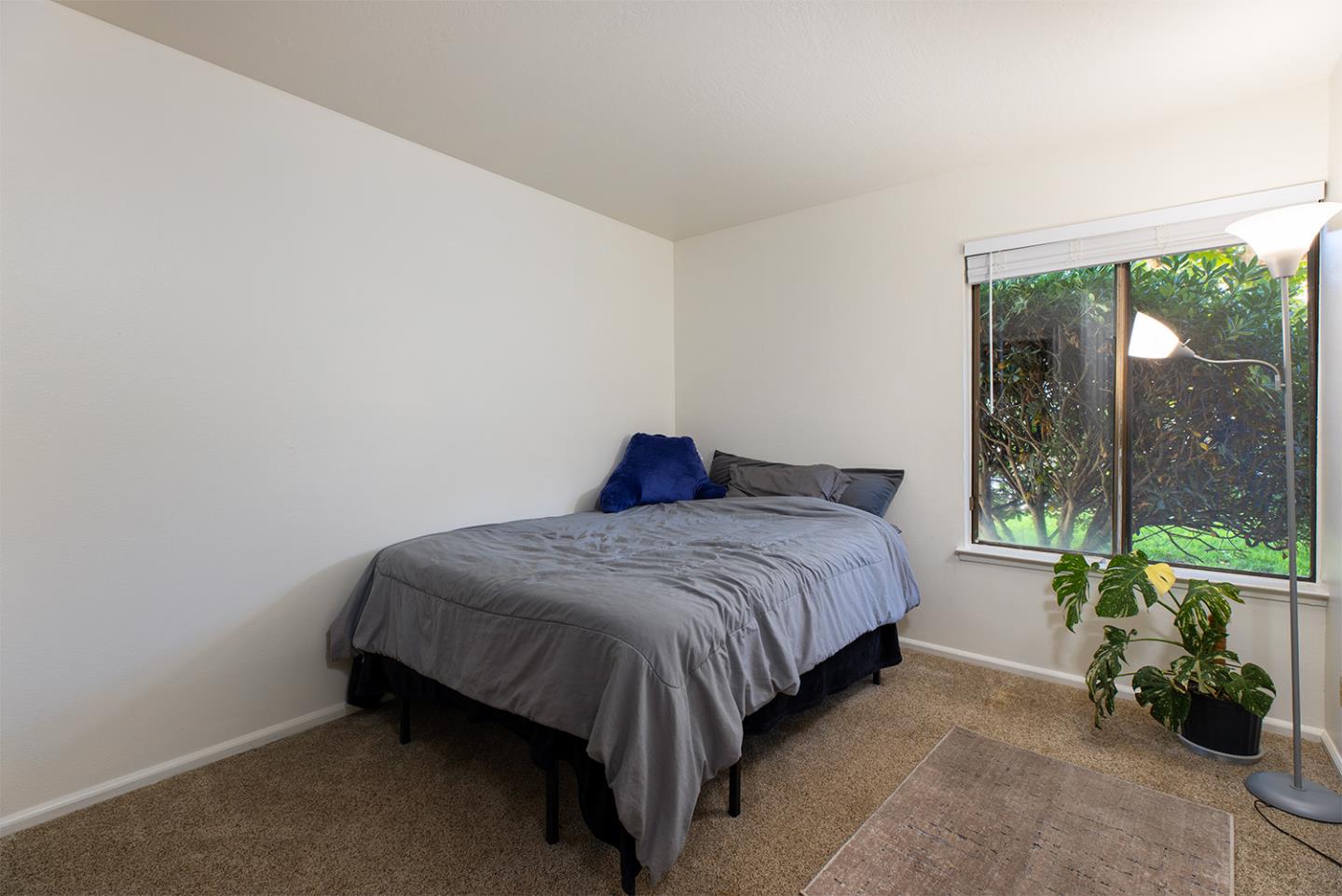 1925 46th Avenue, Unit 121 Capitola, CA 95010 - Photo 11 of 22 a bedroom with a bed lamp and window