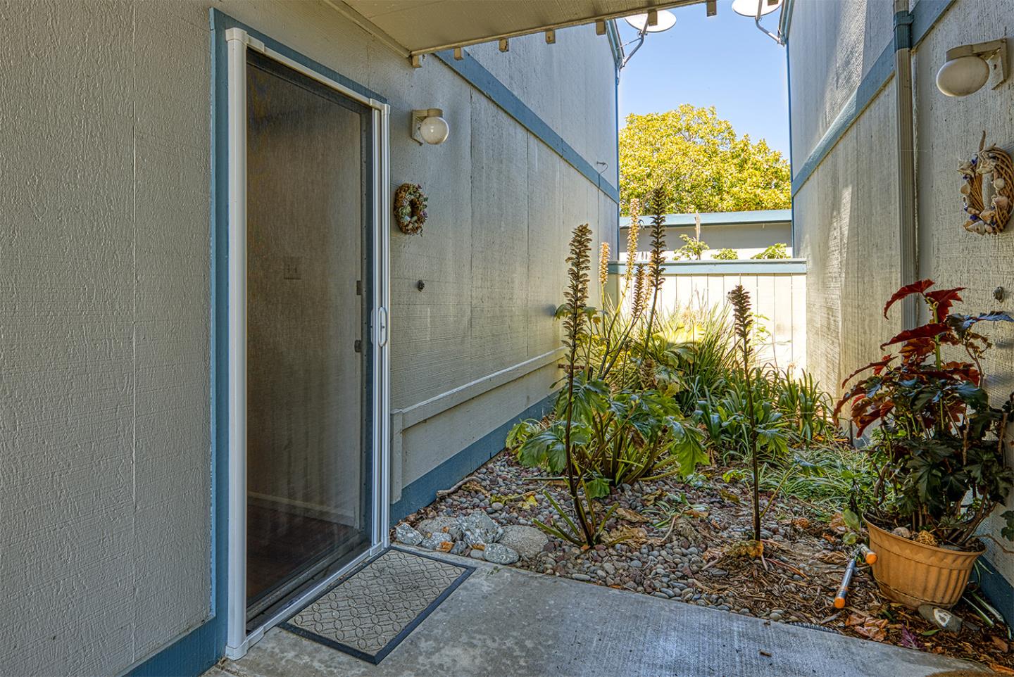 1925 46th Avenue, Unit 121 Capitola, CA 95010 - Photo 3 of 22 a view of a potted plants in front of a door