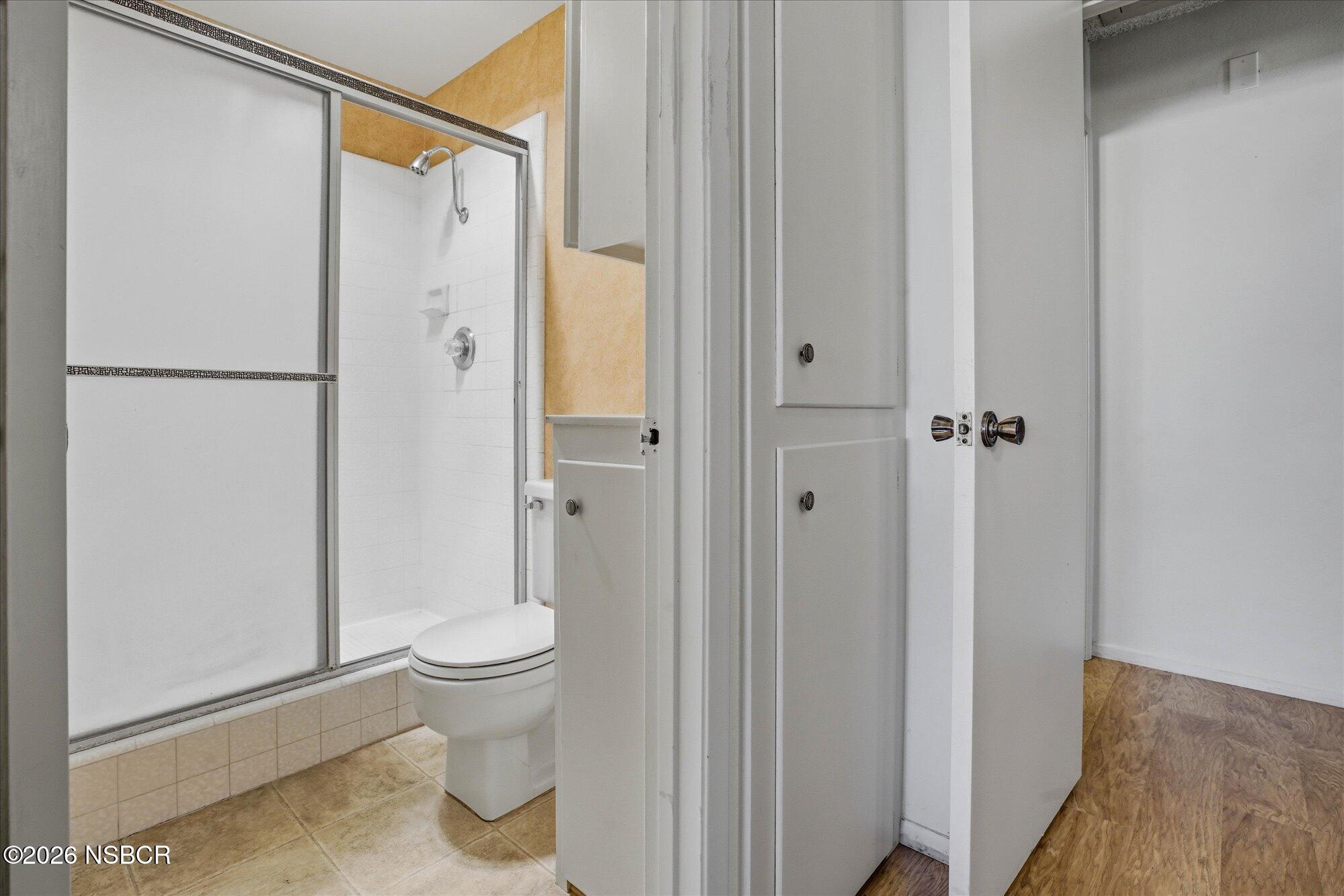 166 Tallyho Road Santa Maria, CA 93455 - Photo 13 of 20 a bathroom with a granite countertop sink a toilet and shower