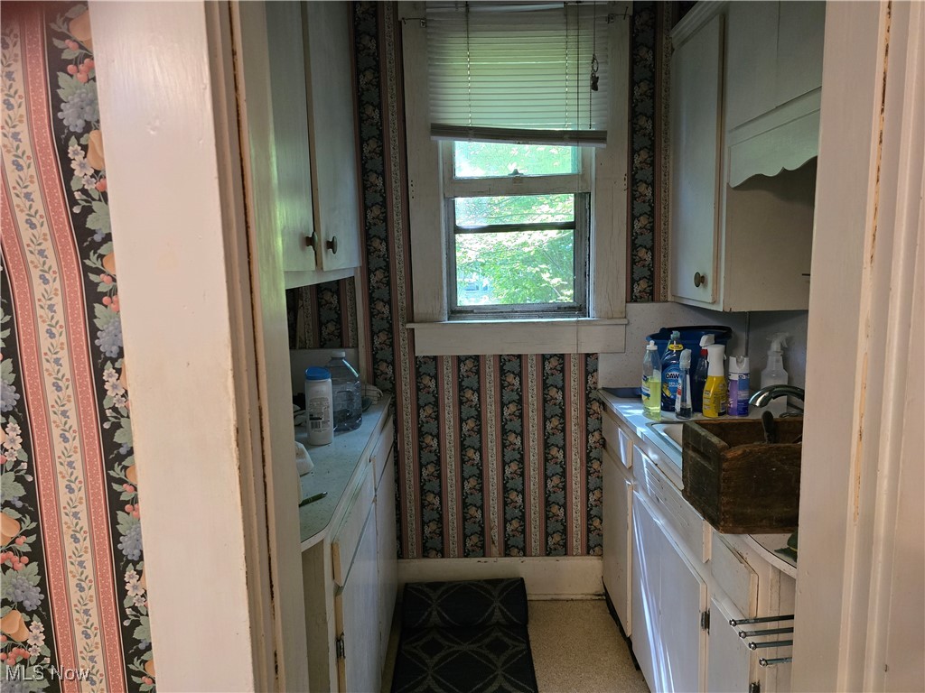 610 Dryden Road Zanesville, OH 43701 - Photo 4 of 13 Bathroom with wallpapered walls and vanity