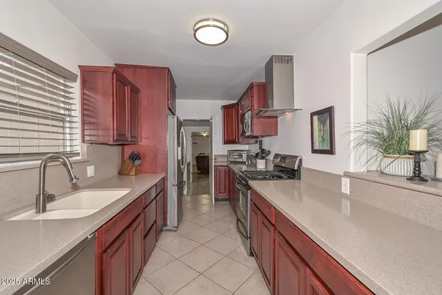 a kitchen with stainless steel appliances granite countertop a sink stove and cabinets
