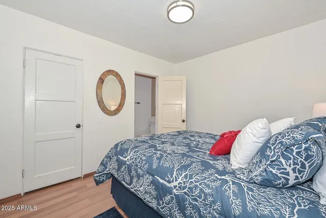 a bedroom with a bed and a chandelier